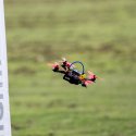 Small drone flying between two flags