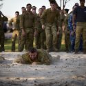 Combat Support Group members race to complete the leopard crawl component of the 2025 Charity Group Workout at RAAF Base Williamtown.