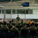 Flight Lieutenant Thomas Rogers from No. 383 Squadron delivers a brief to Australian Defence Force personnel in preparation for the repatriation of Australian nationals, permanent visa holders and approved foreign nationals wishing to return to Australia from New Caledonia.