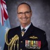 Chief of Air Force Mel Hupfeld in front of the RAAF ensign in his full dress uniform with medals