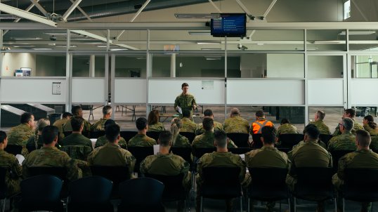 Flight Lieutenant Thomas Rogers from No. 383 Squadron delivers a brief to Australian Defence Force personnel in preparation for the repatriation of Australian nationals, permanent visa holders and approved foreign nationals wishing to return to Australia from New Caledonia.