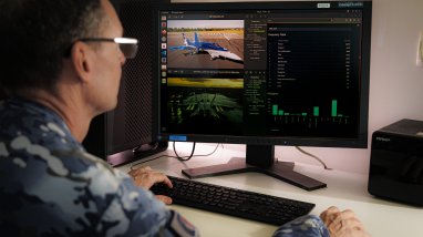 Air Force Imagery Specialist, Flight Sergeant Michael Bott searches for aircraft using an algorithim that he has helped produced while involved in the Edgy-Air Force program.