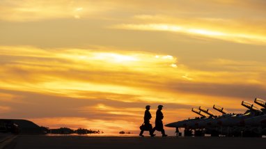 No. 1 Squadron aircrew walking out to their F/A-18F Super Hornets as the sun sets at RAAF Base Darwin, Northern Territory during Exercise Arnhem Thunder 21.