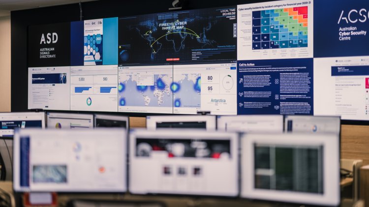 Several rows of computer screens displaying various maps, graphs and images