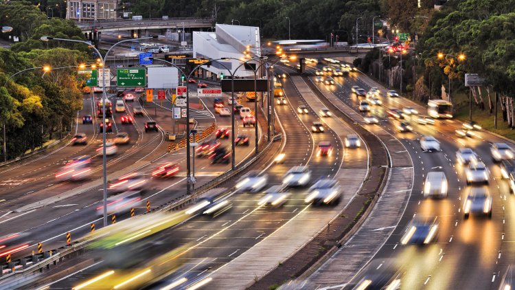 Photo of multi lane highway with cars at dusk