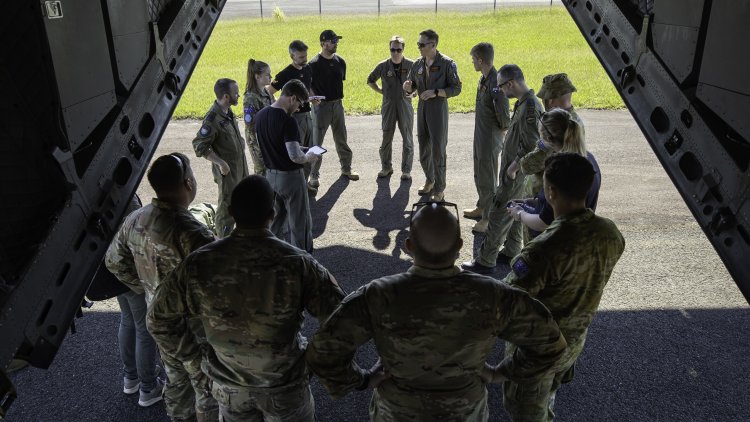 Royal Australian Air Force personnel from 35 Squadron brief United States Army soldiers before they board a Royal Australian Air Force C-27J Spartan during Exercise Croix Du Sud 2023.