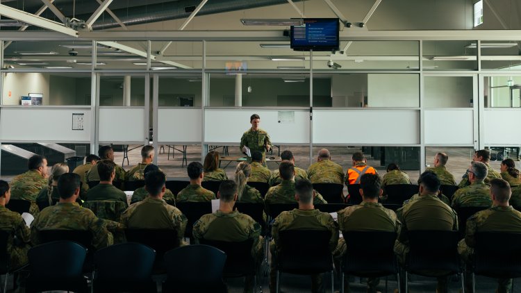 Flight Lieutenant Thomas Rogers from No. 383 Squadron delivers a brief to Australian Defence Force personnel in preparation for the repatriation of Australian nationals, permanent visa holders and approved foreign nationals wishing to return to Australia from New Caledonia.