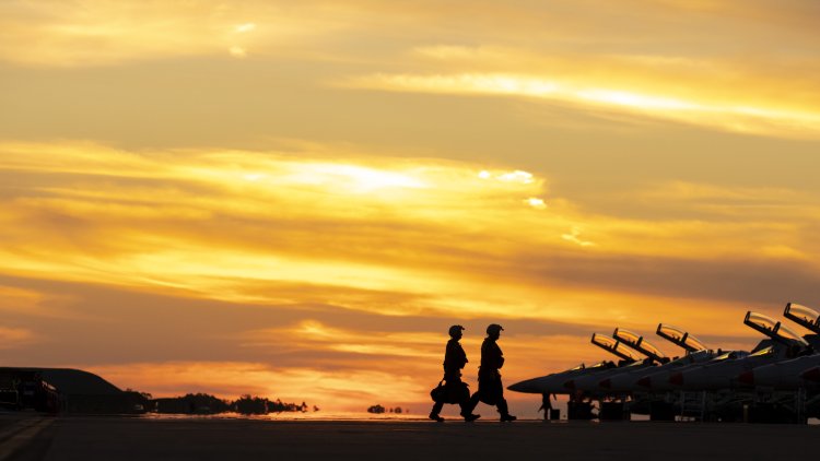 No. 1 Squadron aircrew walking out to their F/A-18F Super Hornets as the sun sets at RAAF Base Darwin, Northern Territory during Exercise Arnhem Thunder 21.